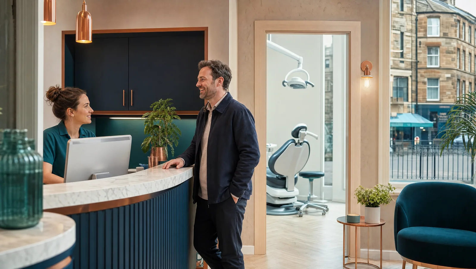 Patient speaking with the dental reception team in a modern Edinburgh practice.